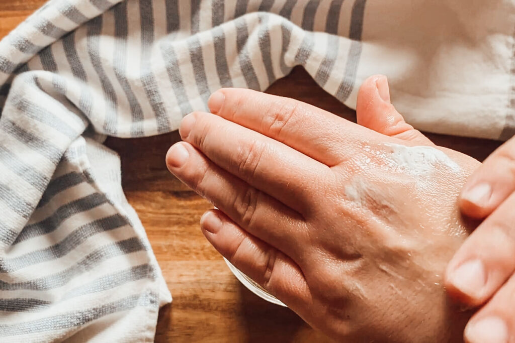 hands applying homemade whipped body butter