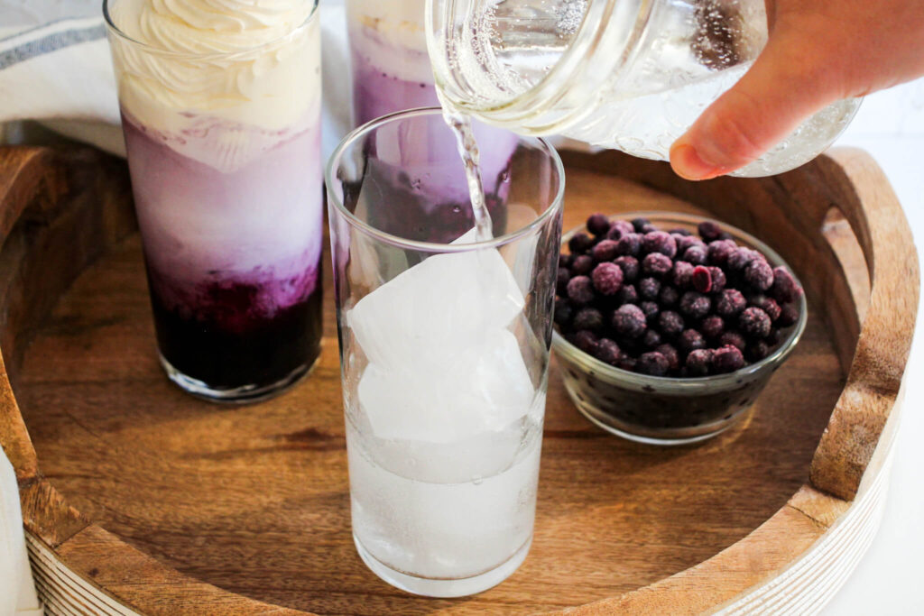 add club soda to the glass to make  blueberry Italian cream soda